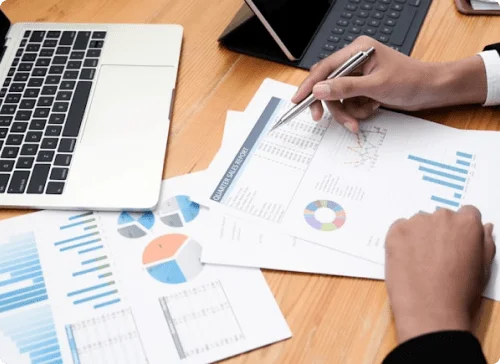 Professional analysts shows metrics chart on a table with a pen